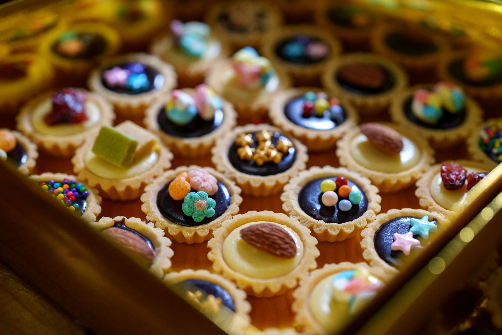 Assorted mini tarts arranged in a dessert box
