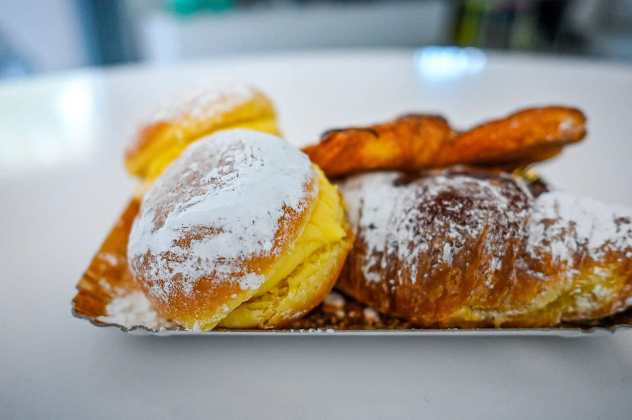 Assorted pastries on a tray with powdered sugar