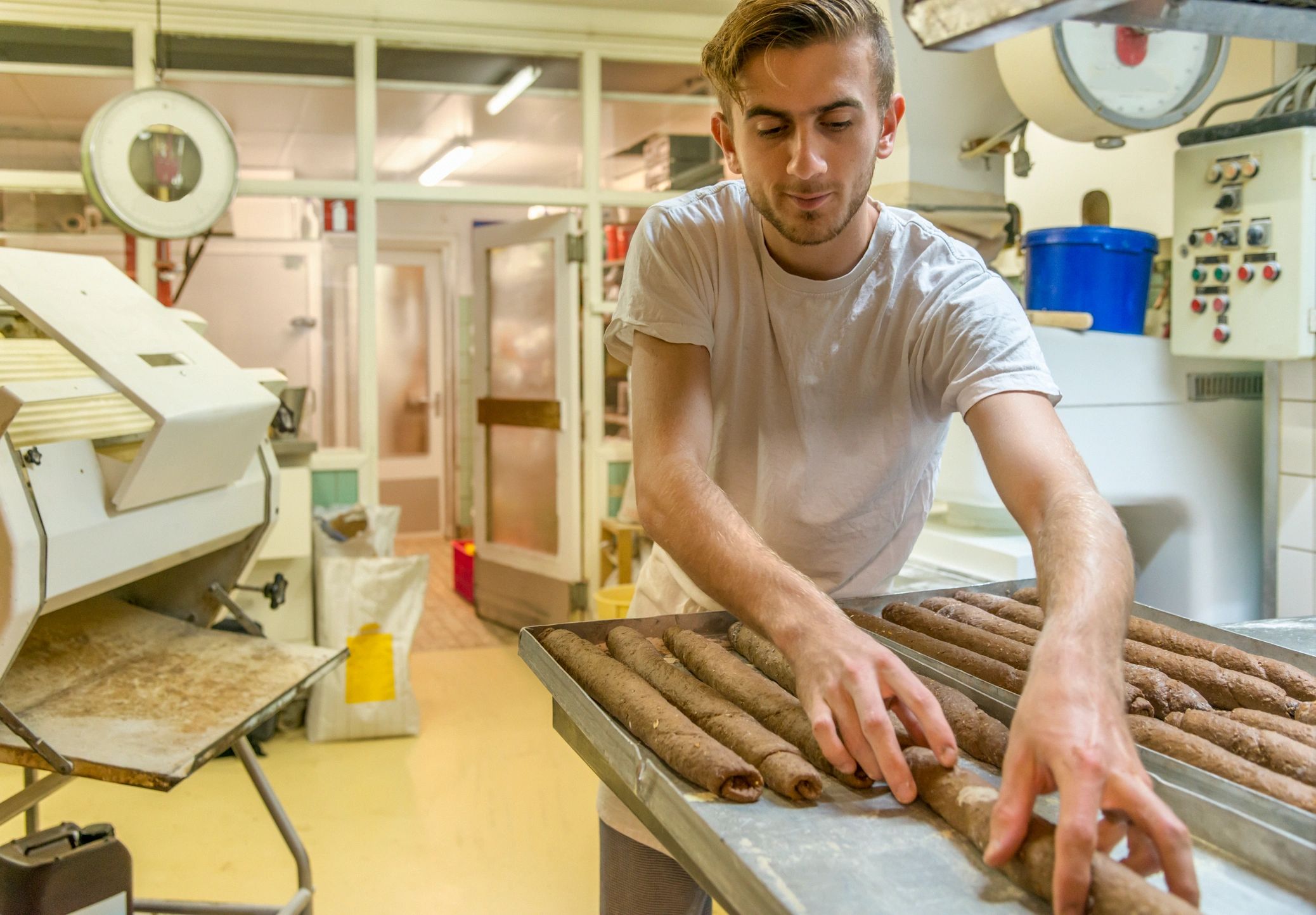 Baker kneading dough for fresh bread