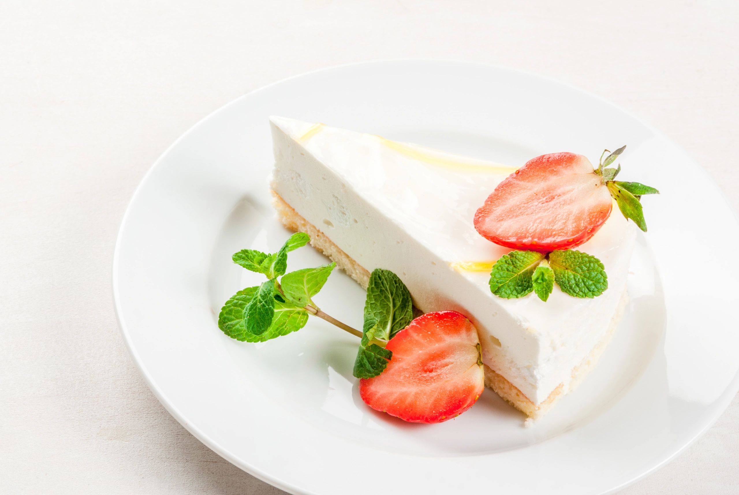 Light dessert on a plate with strawberries and mint